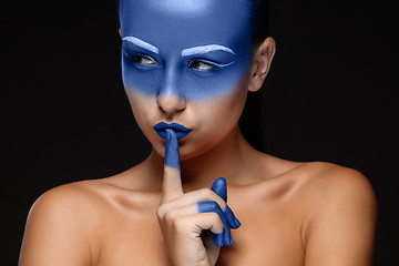 Image showing Portrait of a woman who is posing covered with blue paint