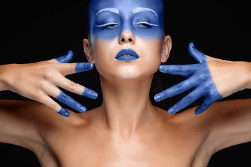 Image showing Portrait of a woman who is posing covered with blue paint