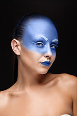 Image showing Portrait of a woman who is posing covered with blue paint