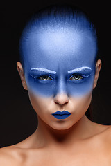 Image showing Portrait of a woman who is posing covered with blue paint