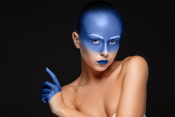 Image showing Portrait of a woman who is posing covered with blue paint