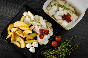 Image showing Delicious portion of rustic potatoes fillet with aromatic herbs