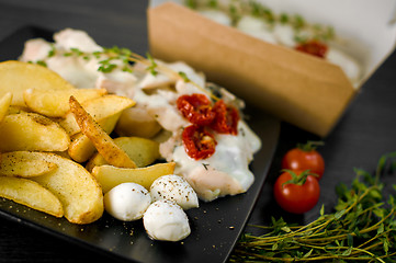 Image showing Delicious portion of rustic potatoes fillet with aromatic herbs