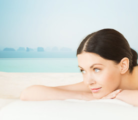 Image showing happy beautiful woman lying in spa