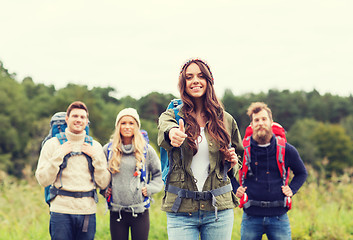 Image showing group of smiling friends with backpacks hiking