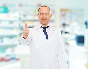 Image showing smiling pharmacist showing thumbs up at drugstore