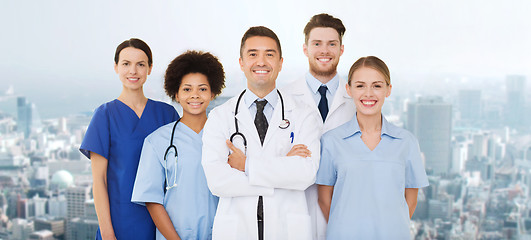 Image showing group of happy doctors over blue background