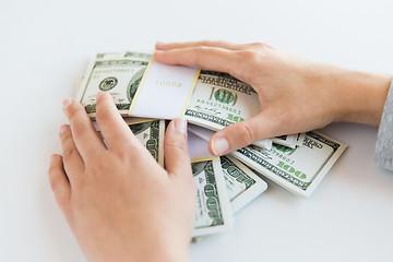 Image showing close up of woman hands counting us dollar money