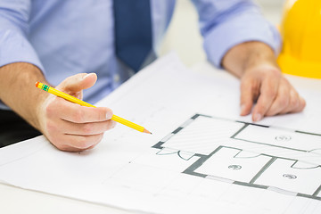 Image showing close up of male hand with blueprint and pencil