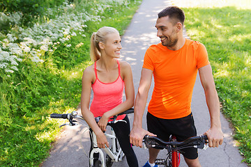 Image showing happy couple riding bicycle outdoors