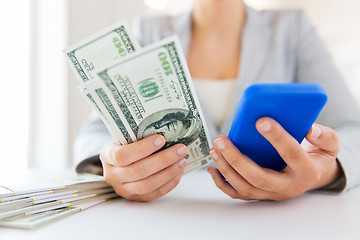 Image showing close up of woman hands with smartphone and money