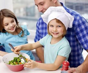 Image showing happy family with two kids cooking at home