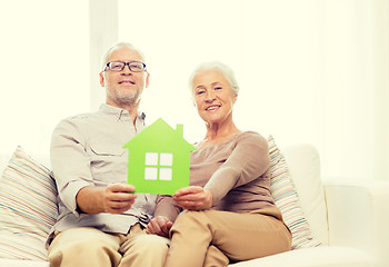 Image showing happy senior couple hugging on sofa at home