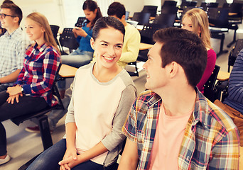 Image showing group of smiling students in lecture hall