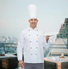 Image showing happy male chef cook showing empty plate