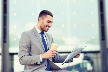 Image showing young businessman with coffee and newspaper