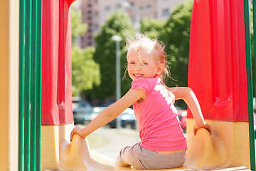 Image showing happy little girl on slide at children playground