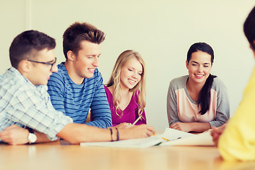 Image showing group of smiling students with blueprint