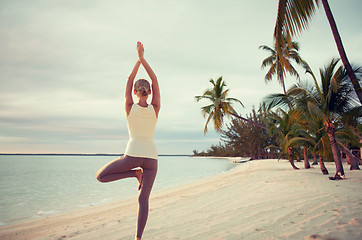 Image showing young woman making yoga exercises outdoors