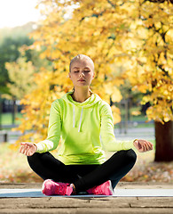 Image showing woman doing yoga outdoors