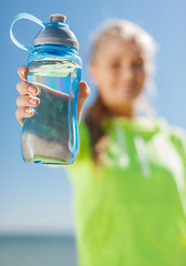 Image showing woman showing a bottle of water