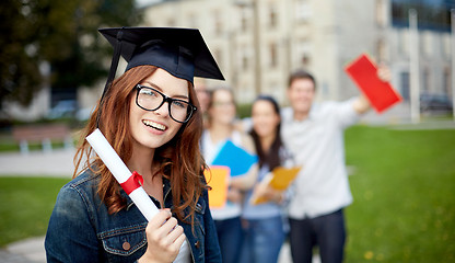 Image showing group of smiling students with diploma and folders