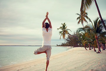Image showing young man making yoga exercises outdoors
