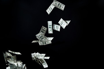 Image showing close up of us dollar money flying over black