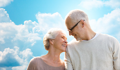 Image showing happy senior couple over blue sky and clouds