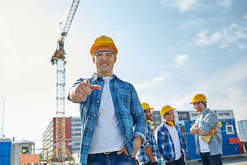 Image showing builders pointing finger at you on construction