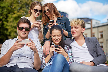 Image showing students or teenagers with smartphones at campus