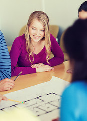 Image showing group of smiling students with blueprint