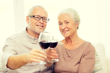 Image showing happy senior couple with glasses of red wine