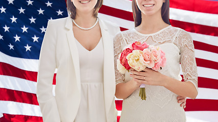 Image showing close up of happy lesbian couple with flowers