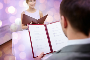 Image showing close up of couple with menu at restaurant