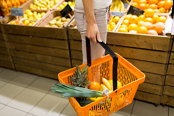 Image showing close up of woman with food basket in market