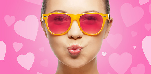 Image showing girl in pink sunglasses blowing kiss