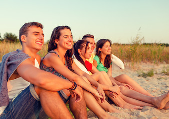 Image showing smiling friends in sunglasses on summer beach