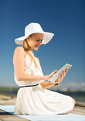 Image showing beautiful woman in a dress with tablet pc