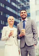 Image showing smiling businessmen with paper cups outdoors