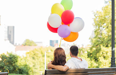 Image showing happy couple with air balloons in city