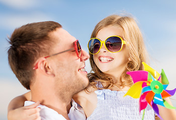 Image showing happy father and child in sunglasses over blue sky