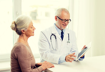 Image showing smiling senior woman and doctor with tablet pc