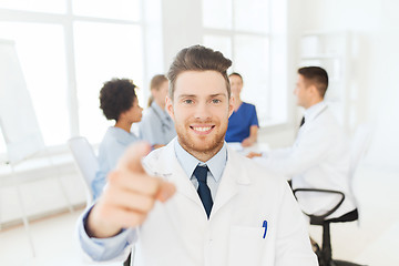 Image showing happy doctor over group of medics at hospital