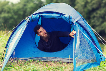 Image showing smiling male tourist with beard in tent