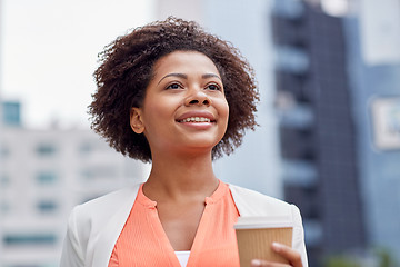 Image showing happy african businesswoman with coffee in city