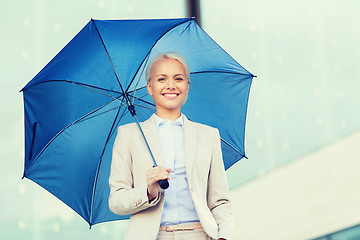 Image showing young smiling businesswoman with umbrella outdoors