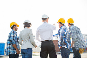 Image showing group of builders and architects at building site