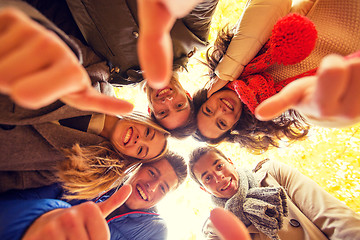 Image showing group of smiling men and women in autumn park