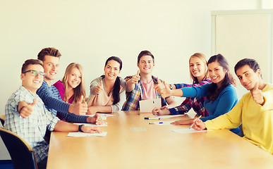 Image showing group of smiling students with hand on top